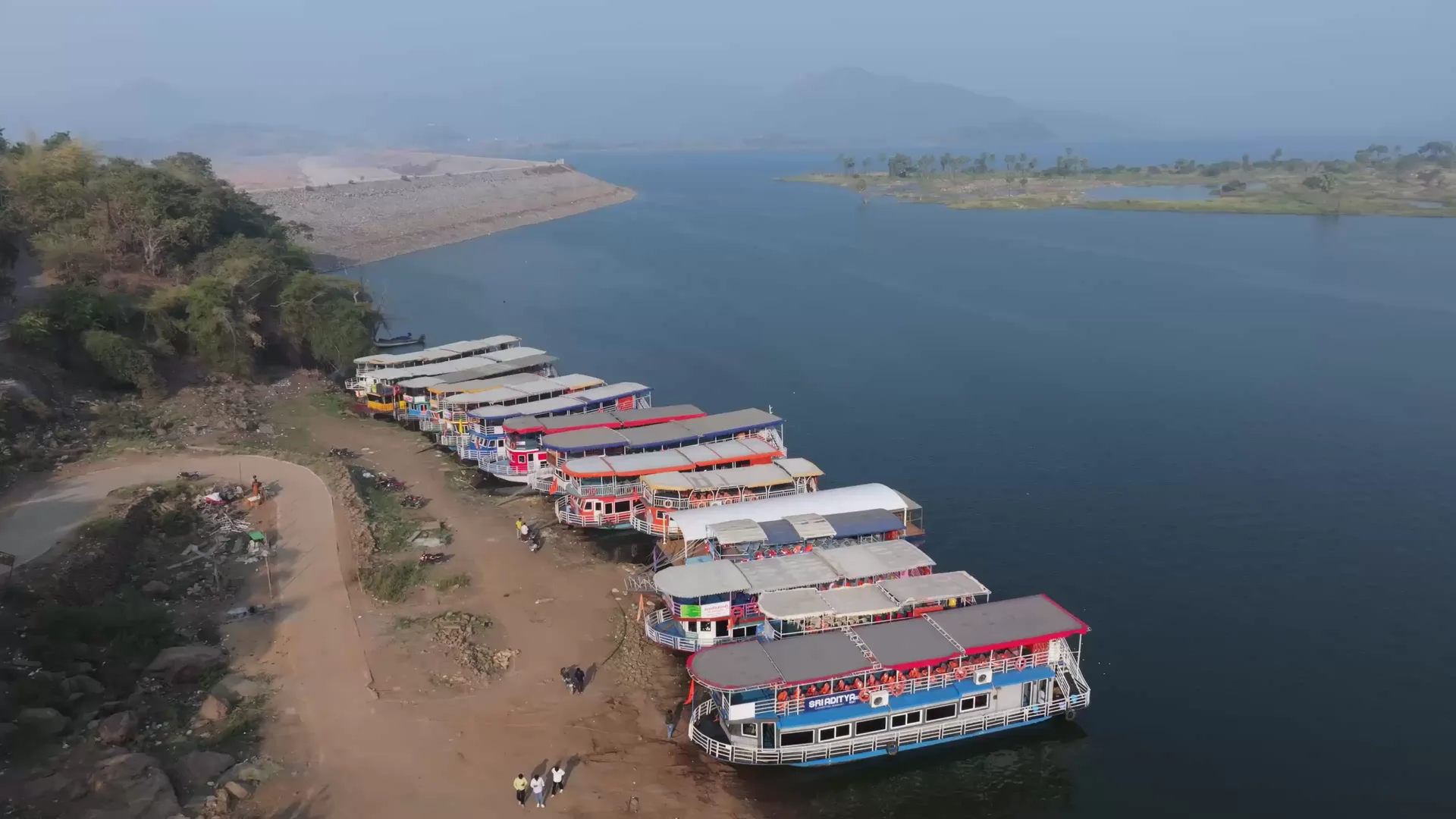 Tourist launches moored in a row on the Godavari bank below the Papikondalu hills, seen from the air