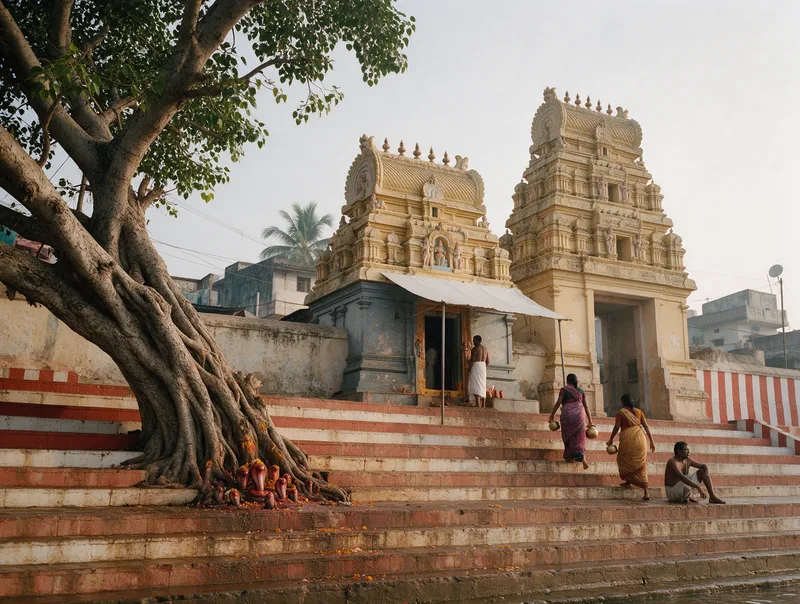 Ghat steps at Kotilingala Revu rising past an old pipal tree to the Kotilingeswara shrine and its gateway tower