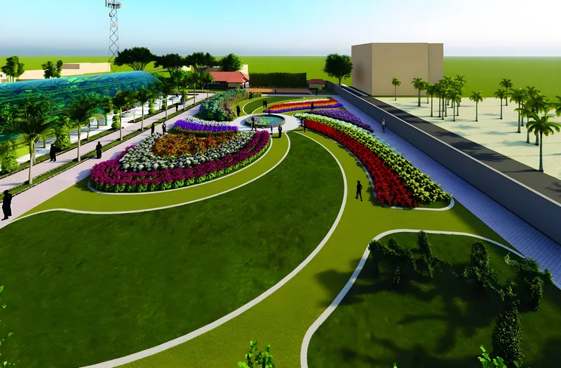The exhibition garden at Kadiyam: curving beds of red, white and purple flowers around a lawn
